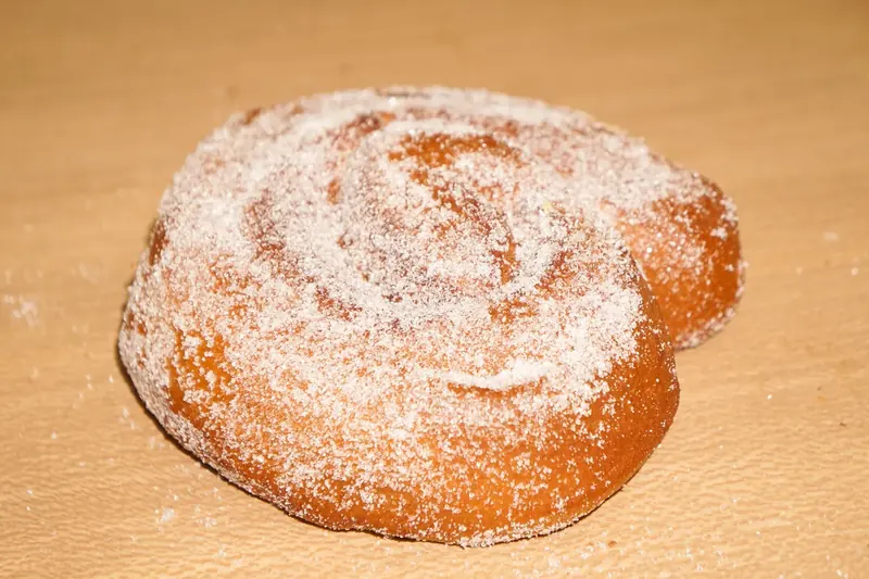 Cinnamon roll coated in cinnamon sugar